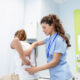 Physiotherapist doing healing treatment on womans back back pain patient treatment medical doctor massage therapistoffice syndrome